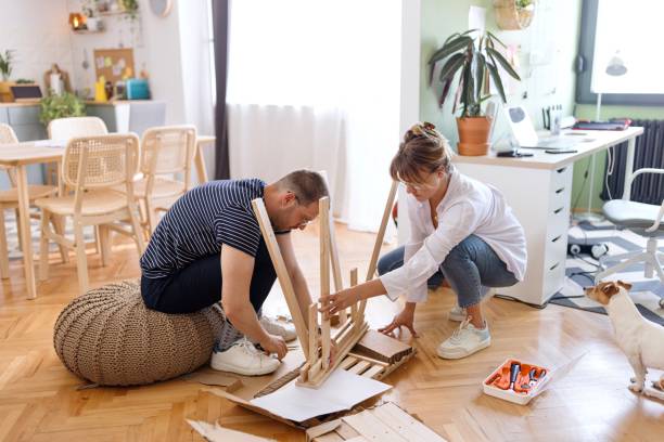 istock Modern couple engaged in the process of assembling a new table 2152765970