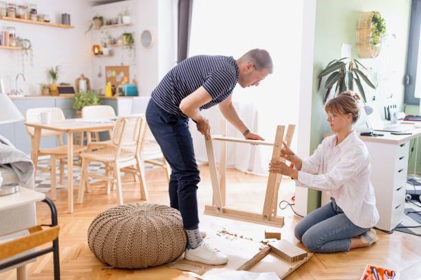 istock Beautiful couple engaged in the process of assembling a new table 2152765977