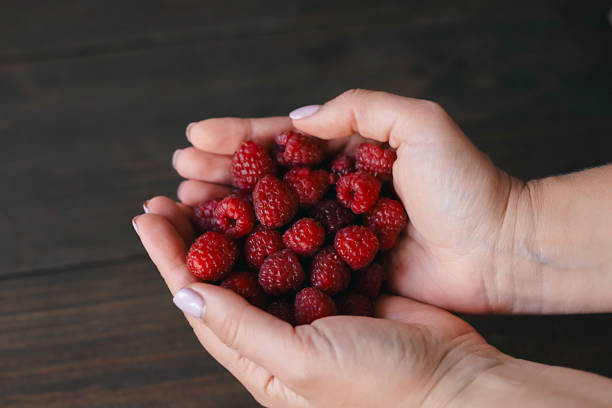 Raspberries on wooden background. Harvest
