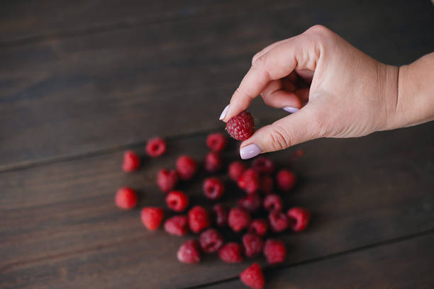 Raspberries on wooden background. Harvest