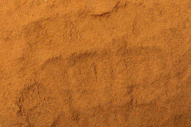 istock Cinnamon powder  on background. Spicy spice for baking, desserts and drinks. Fragrant ground cinnamon. Cinnamon stick. Place for text. Copy space. 2152767211