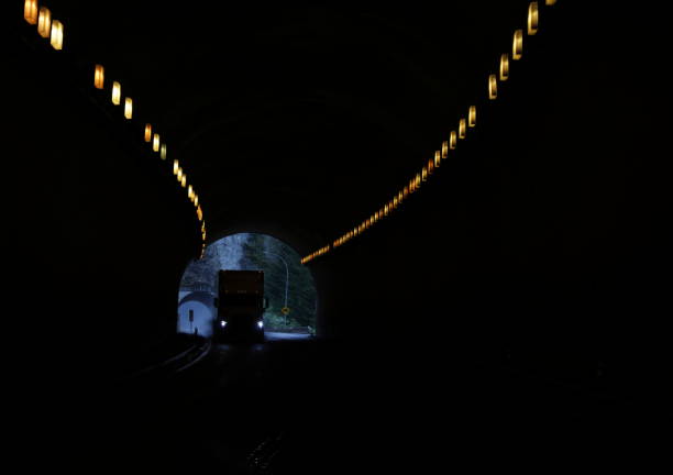 Ferrabee Tunnel, Canada - April 28, 2024: Looking south through Ferrabee Tunnel as a freight truck travels north on the Trans-Canada Highway. Background shows part of  Hells Gate Tunnel. Spring afternoon in the Fraser Canyon in the Coast Mountains.