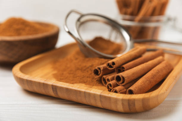 istock Cinnamon sticks on a textured wooden background. Cinnamon roll. Spicy spice for baking, desserts and drinks. Fragrant ground cinnamon. cinnamon powder Close-up. Place for text. copy space 2152767973
