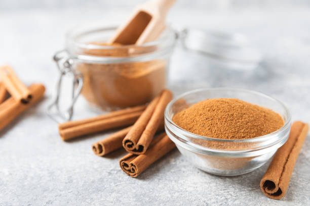 istock Cinnamon powder on background. Spicy spice for baking, desserts and drinks. Fragrant ground cinnamon. Cinnamon stick. Place for text. Copy space. 2152768494