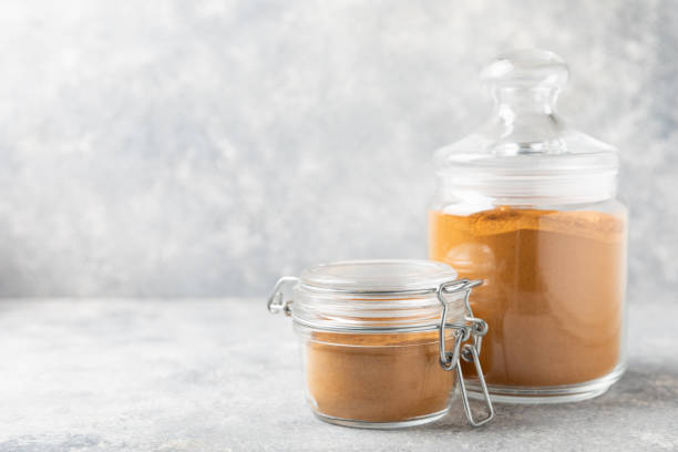 istock Cinnamon powder on background. Spicy spice for baking, desserts and drinks. Fragrant ground cinnamon. Cinnamon stick. Place for text. Copy space. 2152768496