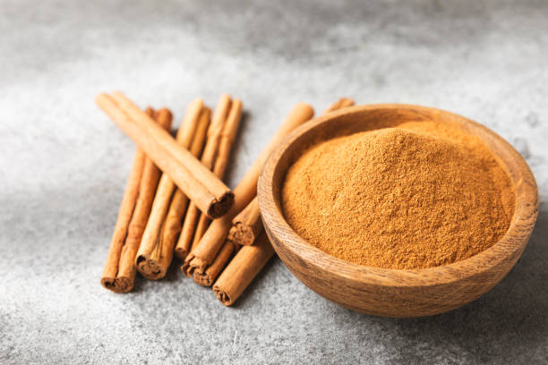 istock Cinnamon powder on background. Spicy spice for baking, desserts and drinks. Fragrant ground cinnamon. Cinnamon stick. Place for text. Copy space. 2152768524