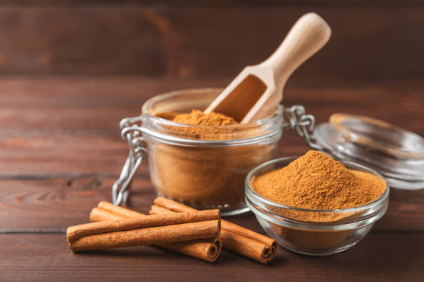 istock Cinnamon powder on background. Spicy spice for baking, desserts and drinks. Fragrant ground cinnamon. Cinnamon stick. Place for text. Copy space. 2152768530