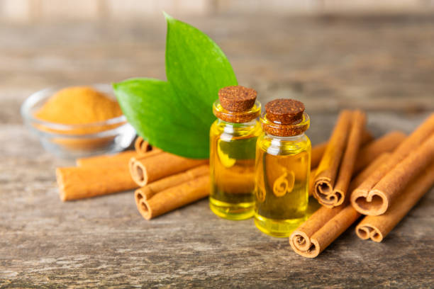 istock Cinnamon aromatic essential oil and cinnamon sticks on  background. Aromatherapy. Organic cosmetic oil. Spa concept. Place for text. Copy space. 2152768604