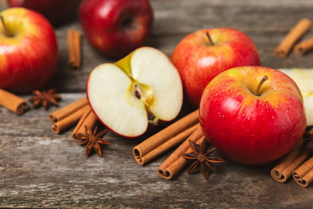 istock Apples with cinnamon on background. Fragrant red spiced apples with cinnamon sticks and star anise. Apple slices with spicy spices. Place for text. Copy space. Harvesting. Fruits. 2152768687