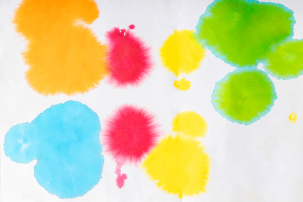 Creative abstract spots of colorful pigments and aquarelle on paper as background for design