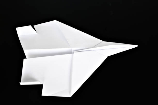 istock White paper airplane isolated on black background. 2152771570