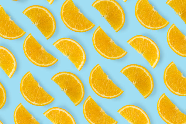 istock Citrus orange pieces on a blue bright background 2152773414