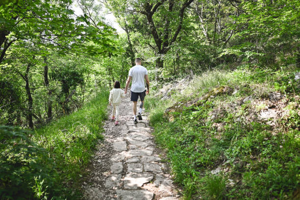 Family hiking in spring forest.