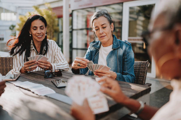 istock women playing cards 2152776642
