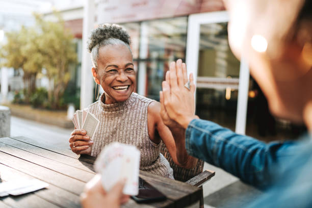 istock Senior women friends playing cards 2152776800