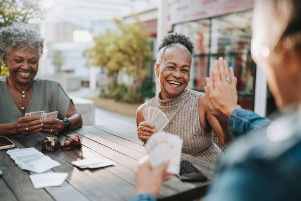 istock Senior women friends playing cards 2152776802
