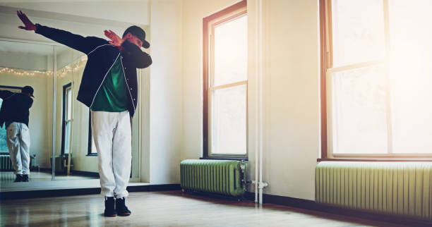 istock Dance, music and man in studio with practice for concert, recital or performance at creative school. Art, hip hop and dancer moving to song, playlist or radio for rehearsal with energy and rhythm. 2152777864