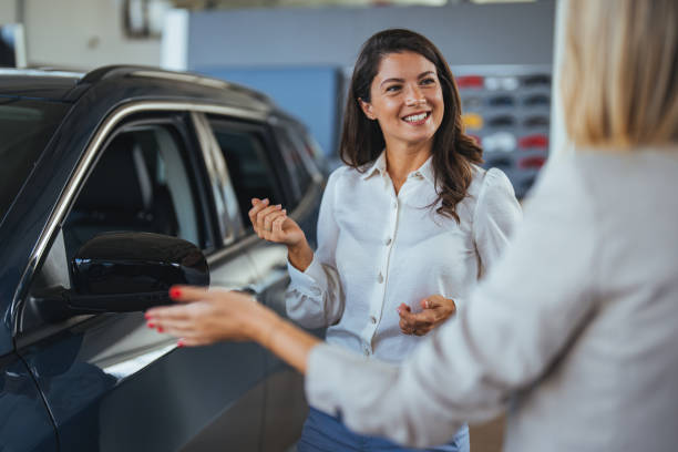 istock Car dealership manager helps a client choose a car. 2152778196