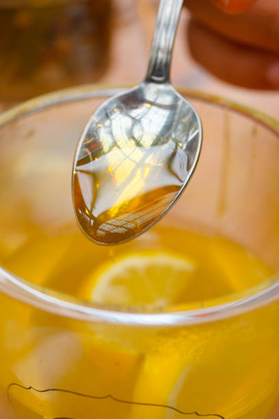 istock pouring honey in a cup of tea 2152778619