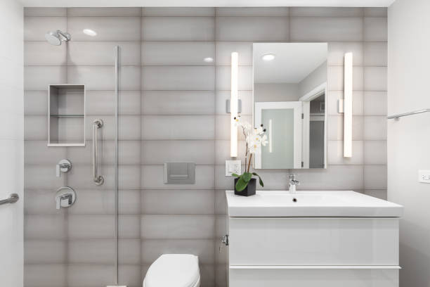 istock A luxury bathroom with a grey tiled wall and a white floating cabinet. 2152782844