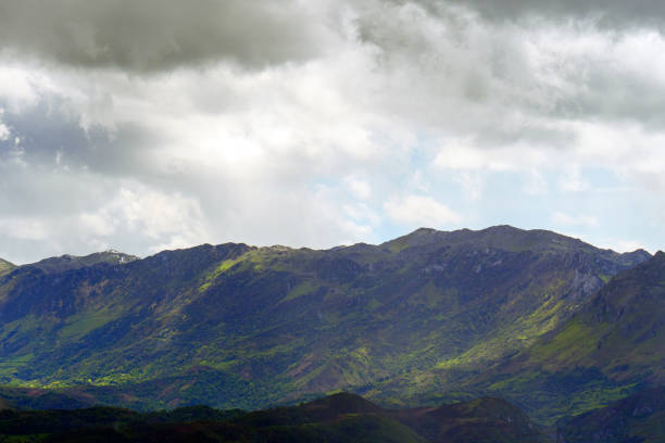 istock Dramatic view of mountain peaks with vegetation on slopes 2152783334
