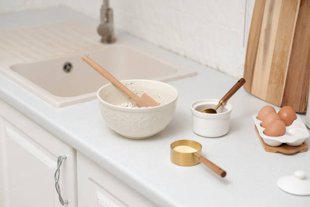 istock Home kitchen interior.Bowl with dough and spatula, eggs and bowl of sugar on kitchen table in modern kitchen. 2152784014