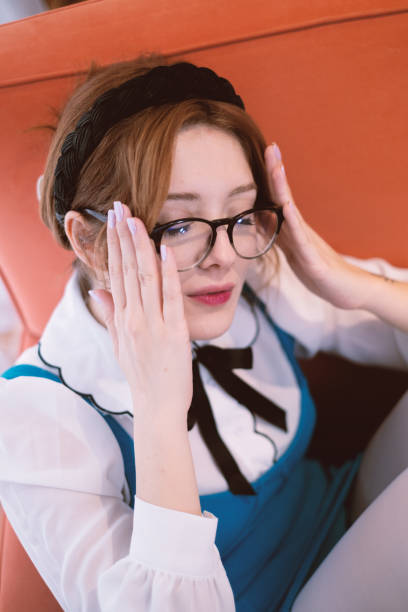 Portrait of beautiful young woman at home with eyeglasses