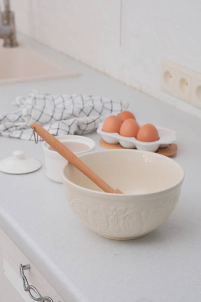 istock Home kitchen interior.Bowl with dough and spatula, eggs and bowl of sugar on kitchen table in modern kitchen. 2152784504