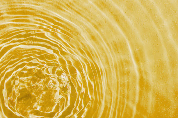 istock drops on water with circles on a yellow background 2152788401
