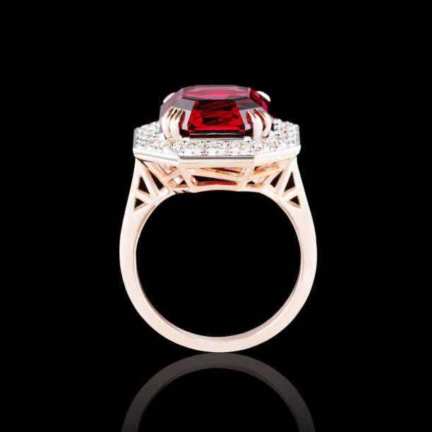 istock Beautiful red gold ring with diamonds and garnet on a black background 2152788469