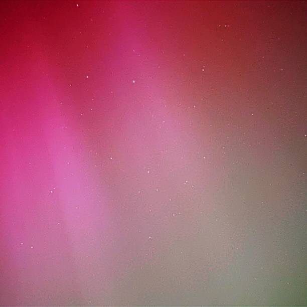 istock The Aurora Borealis Over South Wales Dark pinks, medium pinks and light pinks, mint green, light green, medium green and dark greens with stars showing through the auroral colours 2152789143