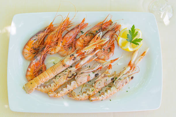 istock Shrimp and Spiny Lobster with Lemon Slice on White Plate 2152790076