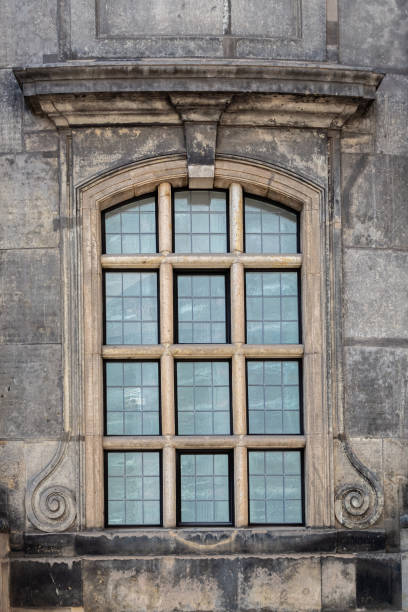 Window of the old Lutheran church Kreuzkirche against the background of a stone wall in the city of Dresden. From the Window of the World series.