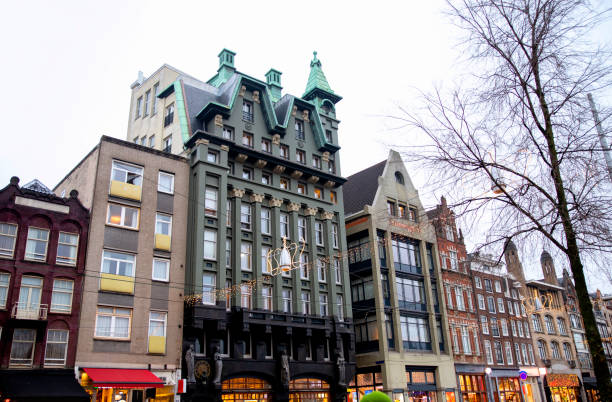 De Utrecht Damrak building facade in green shades among