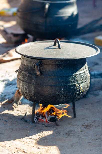 istock three legged african black cast iron pot cauldron, cooking outdoors, slow cooking 2152798673