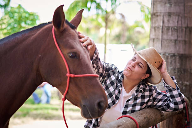 istock Latin woman petting her mare 2152800606