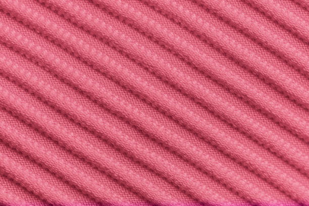 Closeup of pink corduroy cloth as patterned textured background for design purpose