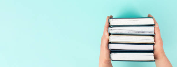 istock Hands holding pile of books, reading and learning new skill, knowledge is power, education concept, university student, back to school 2152801862