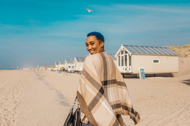 Beautiful diverse woman enjoying down time on a sunny summery day on a beach holiday in the Netherlands