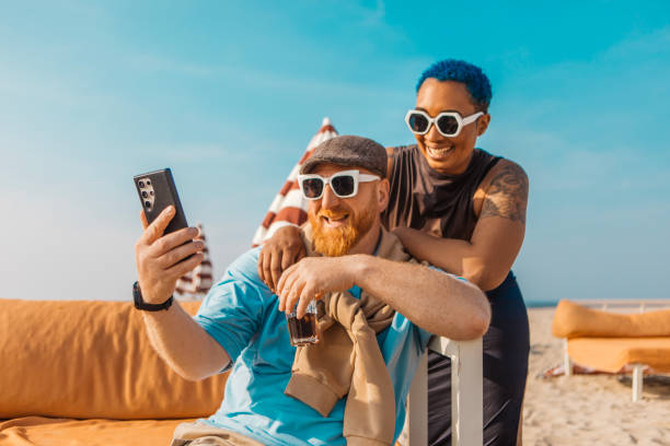istock Two diverse friends on a beach holiday together 2152803207