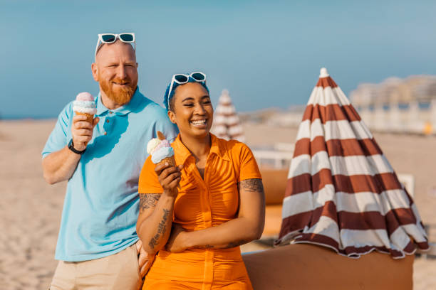 istock Two diverse friends on a beach holiday together 2152803389