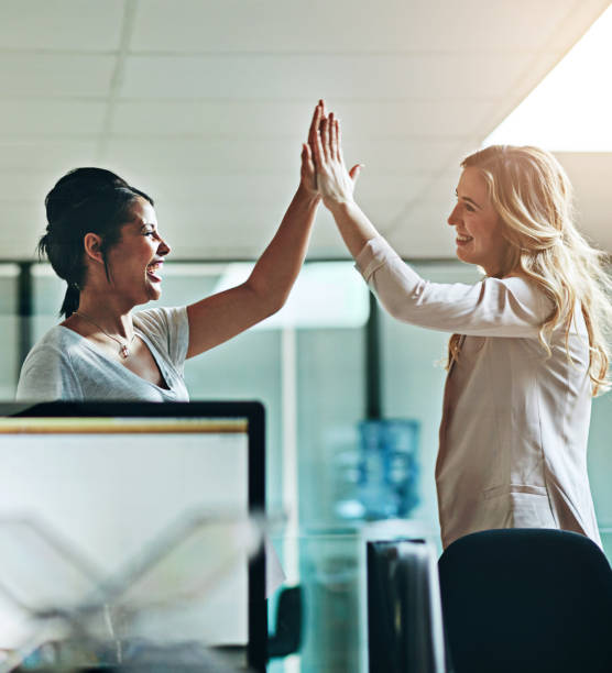 istock Teamwork, support and happy colleagues sharing high five in a modern office, excited about good news or feedback. Female coworkers celebrating success, expressing joy and collaborating on project 2152803612