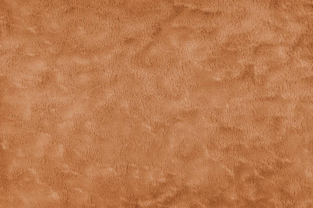 istock Texture of fluffy orange upholstery fabric or cloth. Texture of artificial fur textile material. 2152803993