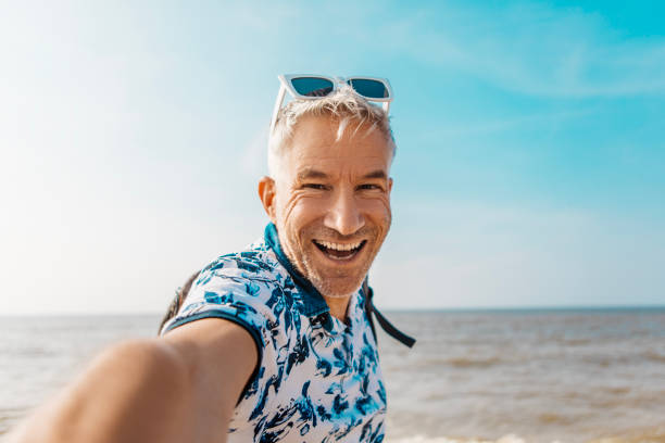 istock Handsome male senior man enjoying down time on a beach holiday 2152804072