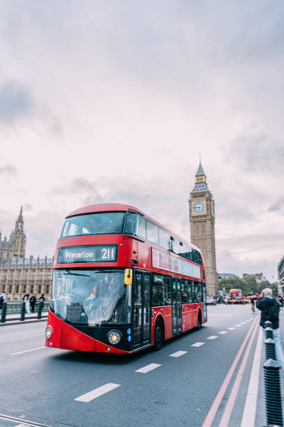 istock Red Double Decker Bus in London passing Big Ben 2152805364