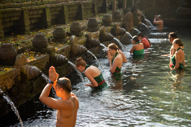Visitors perform a purification ritual called melukat at Tirta Empul Temple in Tampak Siring, which is one of the most famous holy water temples in Bali.
