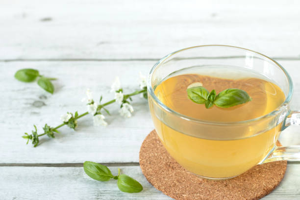 istock Fresh basil tea in glass cup on wooden table, close-up 2152809778