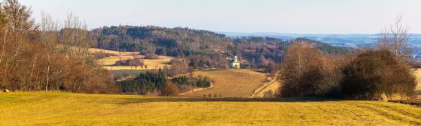 autumn landscape panorama of the Czech-Moravian highlands with fields, woods, meadow and little church near Trebic town, Czech Republic
