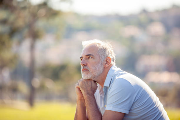 istock Pensive middle age man portrait outdoors looking at view 2152814600