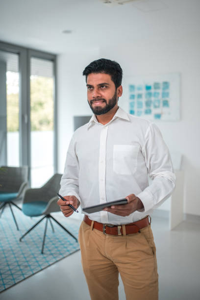 istock Indian Male Professional Holding Tablet in Modern Office 2152815038